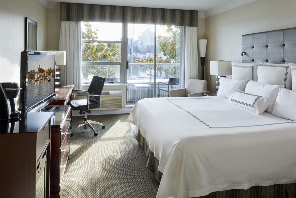 Granville Island Hotel best boutique hotels in Vancouver bed with city and water view